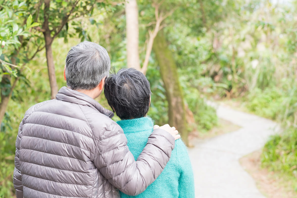 Older couple back of heads outside in the forest